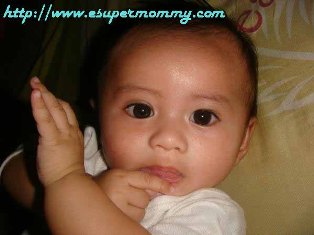 Filipino baby chewing his finger, weaning