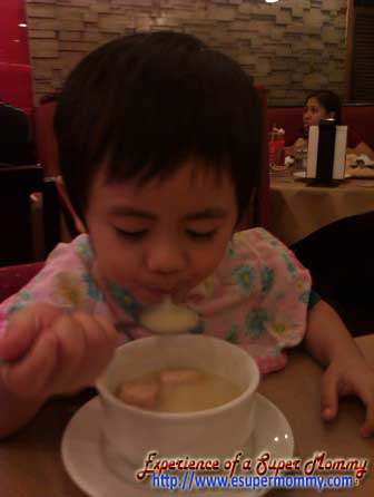 Filipino toddler using a spoon Filipino toddler using a spoon